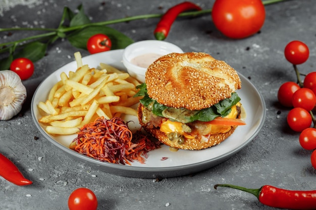 A plate of food with a burger and fries on it