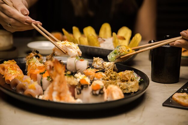 A plate of food with chopsticks and a bowl of food on it