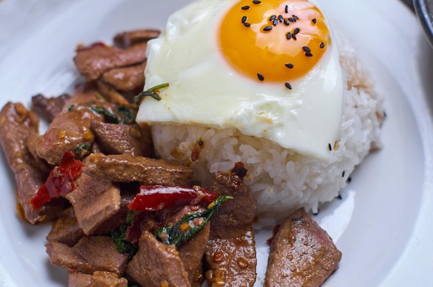 A plate of food with an egg on top