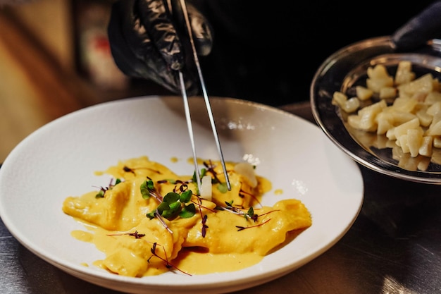 A plate of food with a fork and a bowl of pasta