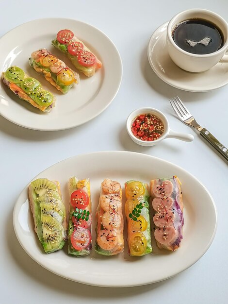 A plate of food with a fork and a cup of coffee on the table.