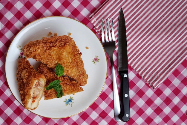 A plate of food with a fork and knife next to it