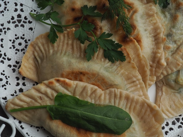 A plate of food with a leafy green leaf on top