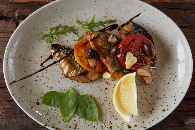 A plate of food with a lemon wedge and a slice of lemon