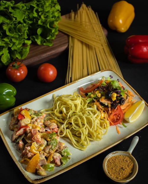 A plate of food with pasta and vegetables on it