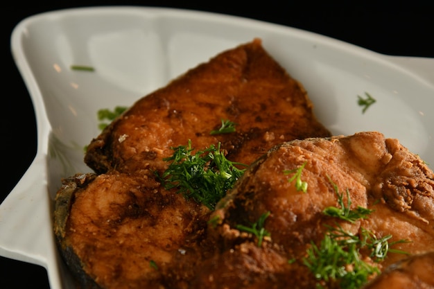 A plate of food with a piece of salmon on it