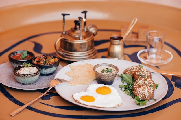 A plate of food with a plate of food on it and a cup of coffee on the table