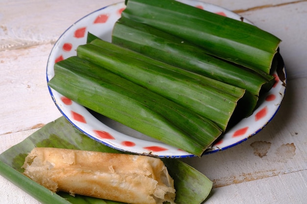 A plate of food with a red and white pattern around the edge surabi