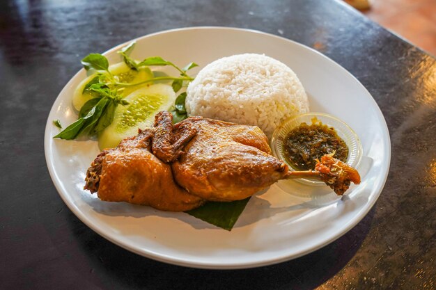 A plate of food with rice and a chicken dish.