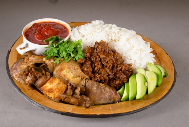 A plate of food with rice, meat, and vegetables.