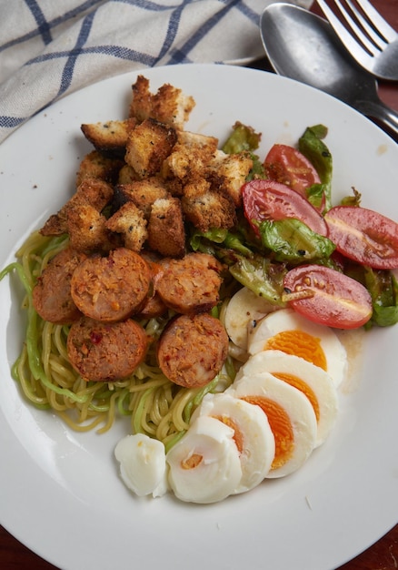 A plate of food with a salad and eggs.