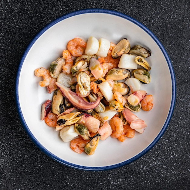 A plate of food with shrimp and mussels on it