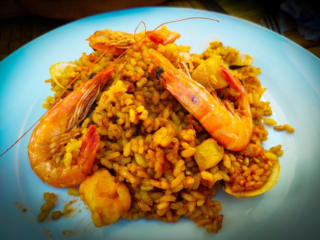 A plate of food with shrimps and rice on it