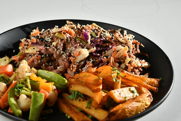 A plate of food with a side of vegetables and a plate of food with a side of vegetables