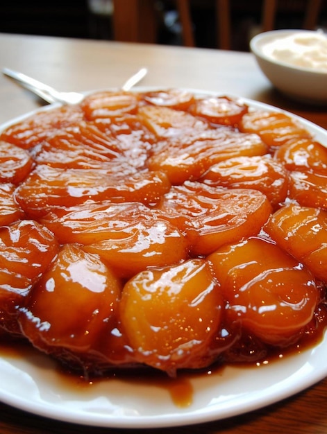 a plate of food with a spoon and a bowl of caramel sauce.