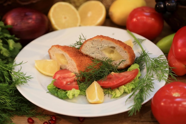 A plate of food with a tomato and cucumber on it