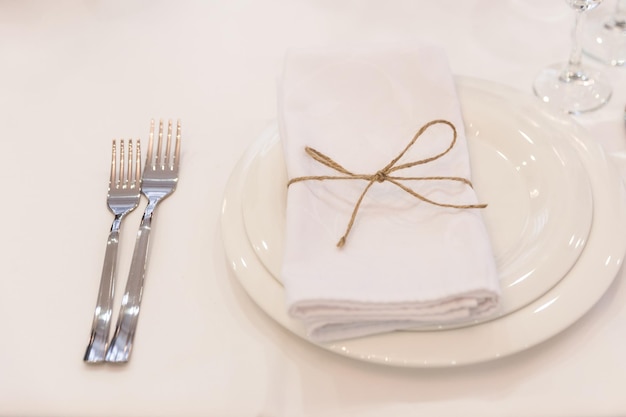 Plate forks napkin and knife in restaurant