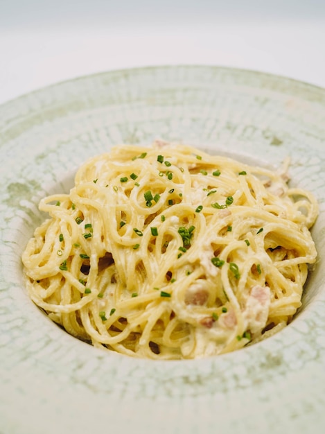 A plate of fresh pasta with alfredo sauce