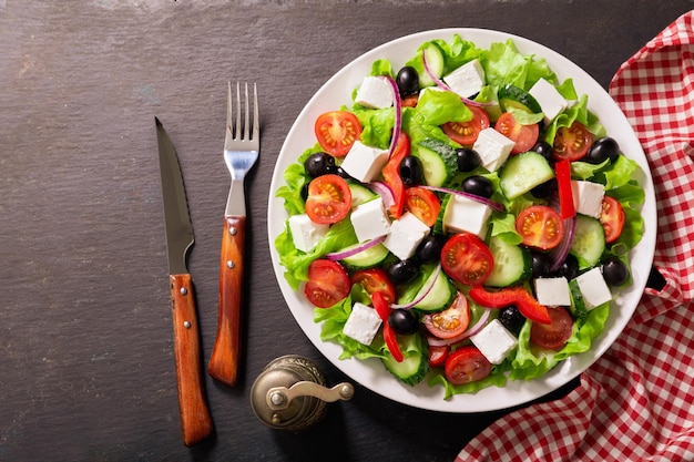 Plate of fresh salad with vegetables feta cheese and olives Greek salad Top view