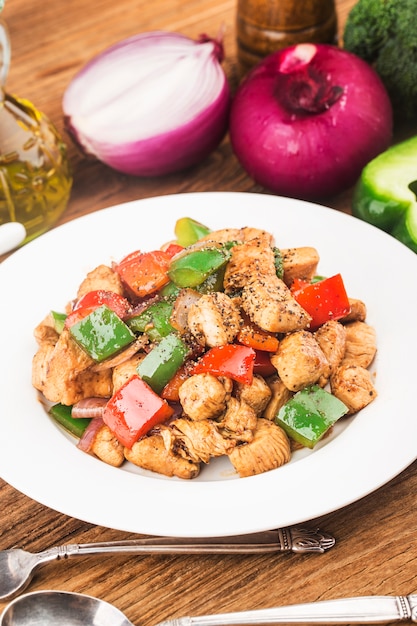 plate of fried chicken breast with colored pepper