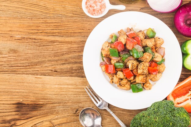 plate of fried chicken breast with colored pepper