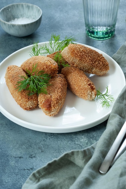 A plate of fried chicken with dill on it