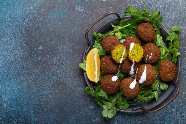 Plate of fried falafel balls served with fresh green