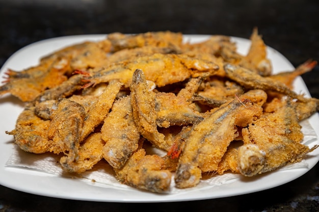 A plate of fried fish with the word fish on it