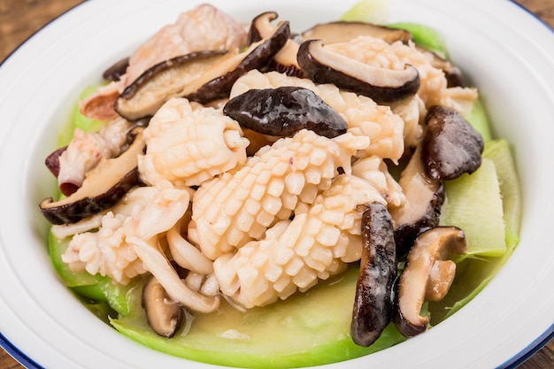 A plate of fried squid with kale head