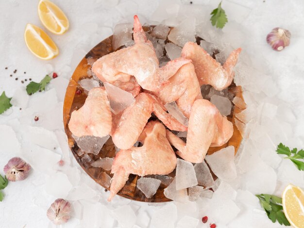 A plate of frozen fish with red pepper on top.