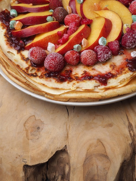 A plate of fruit tart with peaches on it