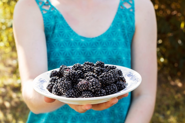 Plate full of fresh organic blackberries