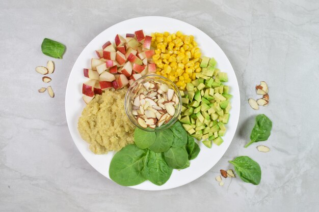 A plate full of heart healthy food and grains atop a modern gray stone countertop