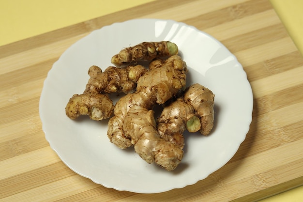 A plate of ginger on a wooden table