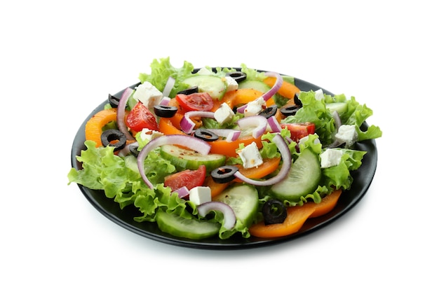 Plate of greek salad isolated on white surface