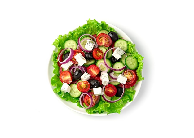 A plate of Greek salad on a white background. Top view. The concept of proper nutrition.