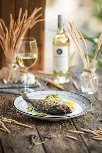 Plate of grilled gourmet fish with white wine