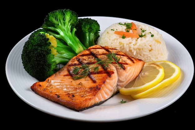 A plate of grilled salmon served with healthful steamed vegetables on a white plate with lemon