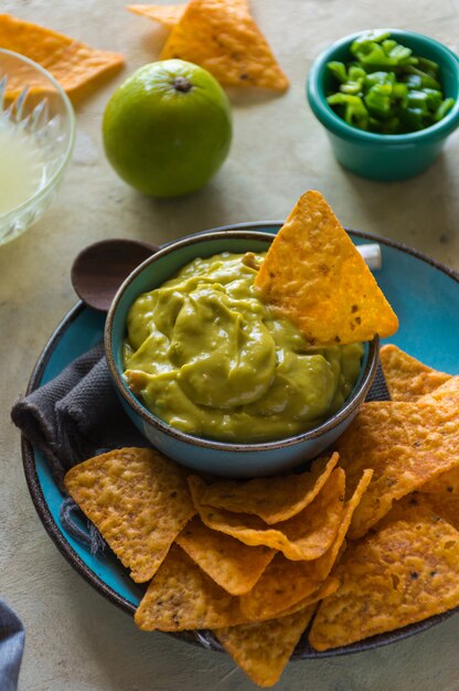 Plate of homemade guacamole with nachos.