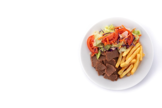 Plate of kebab, vegetables and french fries isolated on white background