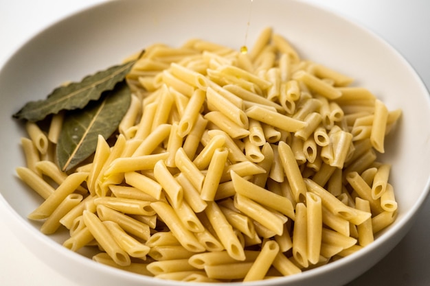 Plate of macaroni cooked with salt pepper and olive oil