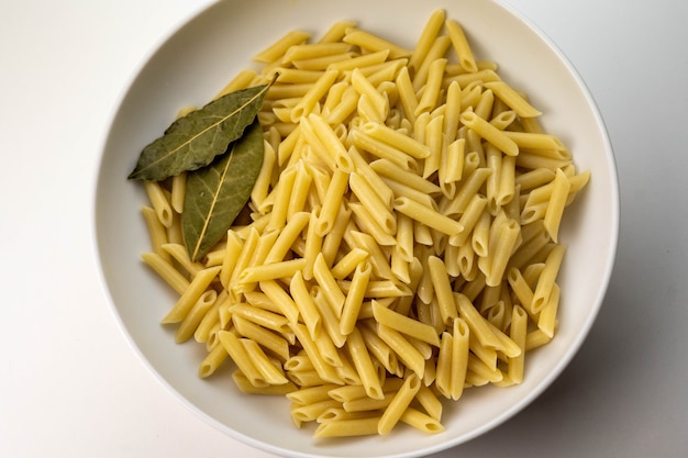 Plate of macaroni cooked with salt pepper and olive oil