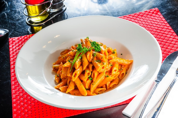 Plate of macaroni dish with tomato sauce.