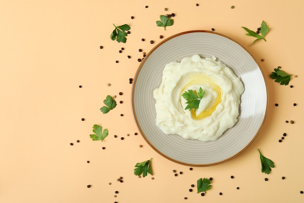 Plate of mashed potatoes and spices on beige