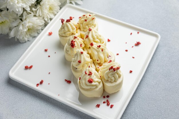 A plate of meringue with a red pepper sprinkle on it.