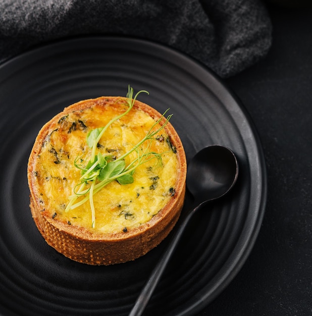 Plate of mini quiche on black plate