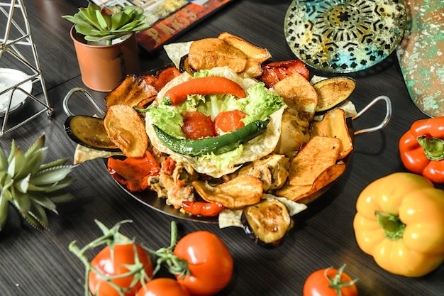 plate of nachos tomatoes and pineapples on table