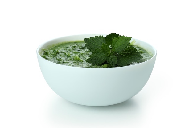 Plate of nettle soup isolated on white background