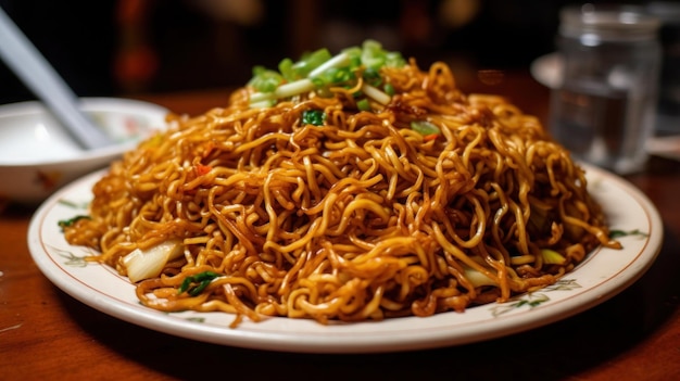 A plate of noodles with a green onion on top.