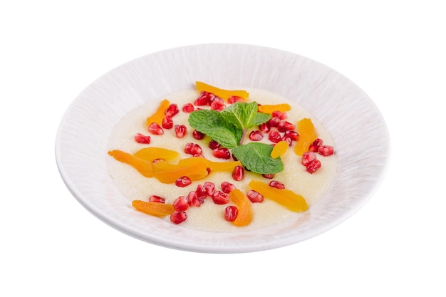 Plate of oatmeal with porridge dried apricots and pomegranates